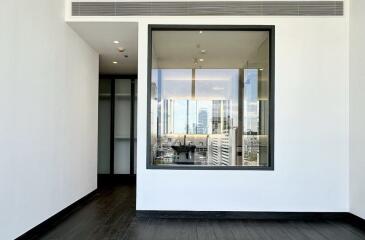 Modern living room with large window providing city view