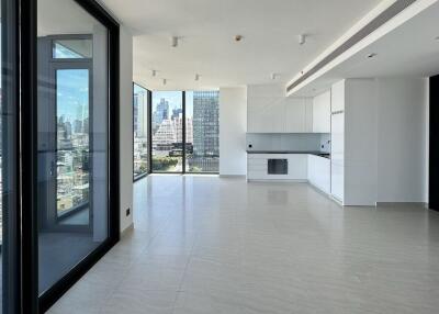 Modern open-plan living area with kitchen and city view