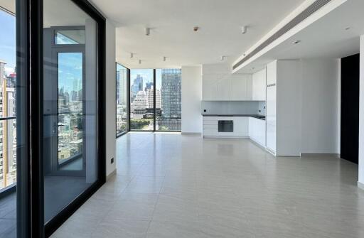 Modern open-plan living area with kitchen and city view