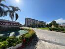 Front view of a building complex with palm trees