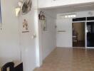 Living room with tiled floor, wall fan, and decorative wall art