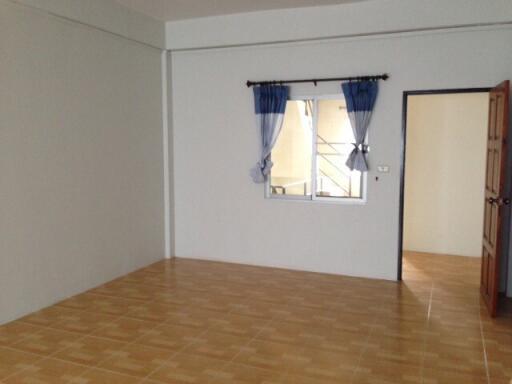 Bright empty bedroom with window and open door