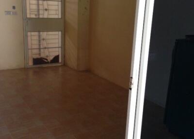 Empty living room with tiled floor and door leading to outside