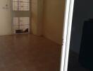 Empty living room with tiled floor and door leading to outside