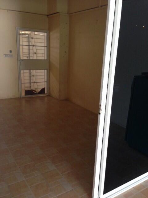 Empty living room with tiled floor and door leading to outside