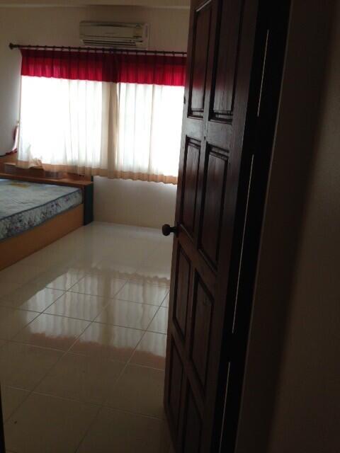 Bedroom with large window and tiled floor