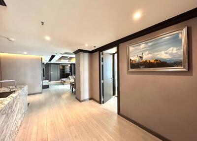 Spacious modern living area with wooden flooring and artwork