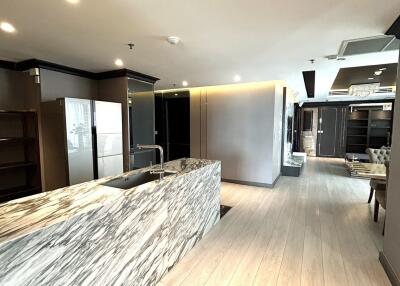 Modern kitchen with marble island and wood flooring