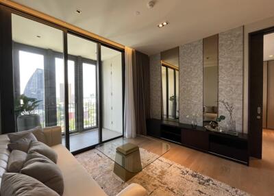 Modern living room with large glass doors leading to a balcony