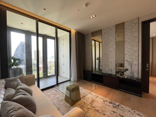 Modern living room with large glass doors leading to a balcony