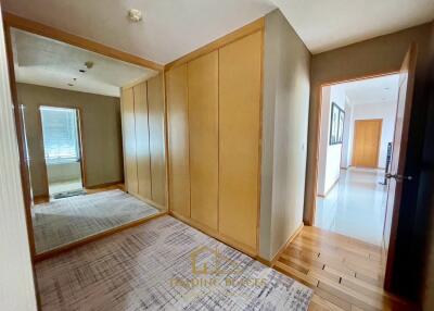 Spacious hallway with wooden flooring and large mirror wardrobe