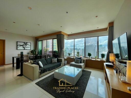 Spacious modern living room with large windows and city view