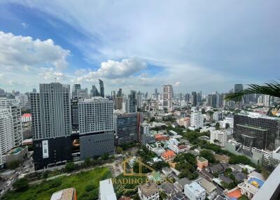 Aerial view of a city with multiple buildings and a cloudy sky