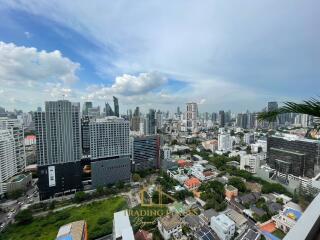 Aerial view of a city with multiple buildings and a cloudy sky