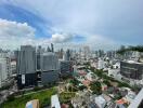 Aerial view of a city with multiple buildings and a cloudy sky