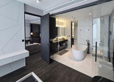 Modern bathroom with glass enclosure and freestanding tub