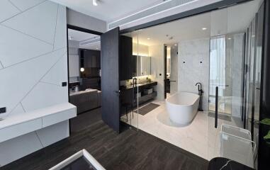 Modern bathroom with glass enclosure and freestanding tub