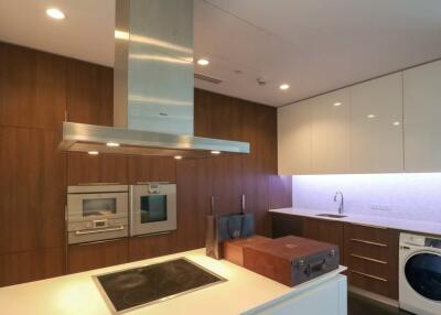 Modern kitchen with built-in appliances and washer