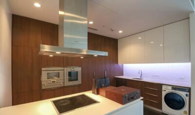 Modern kitchen with built-in appliances and washer