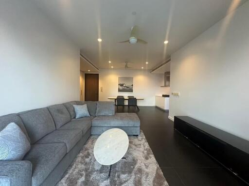 Living room with a sectional sofa, coffee table, and dining area