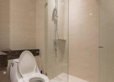 Modern bathroom with glass-enclosed shower and toilet