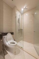 Modern bathroom with glass-enclosed shower and toilet