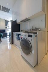 Modern kitchen with appliances and dining area in the background