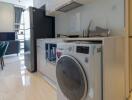 Modern kitchen with appliances and dining area in the background