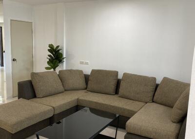 Spacious living room with an L-shaped sofa and a coffee table