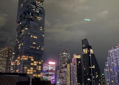 photo of a city skyline with tall buildings at night