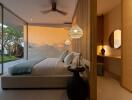 Modern bedroom with a large glass wall, cozy bed, and decorative elements.