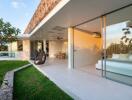 Outdoor patio with seating area and view into modern bedroom