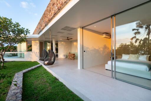 Outdoor patio with seating area and view into modern bedroom