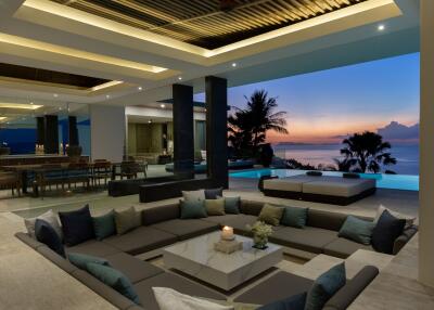 Beautiful open-plan living area with ocean view at sunset