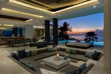 Beautiful open-plan living area with ocean view at sunset