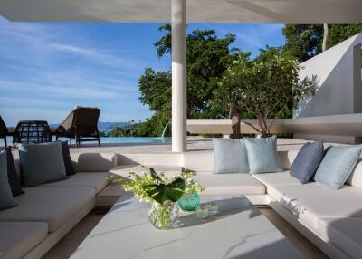 Outdoor living area with modern furniture and pool view