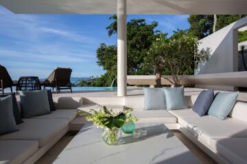 Outdoor living area with modern furniture and pool view