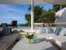 Outdoor living area with modern furniture and pool view