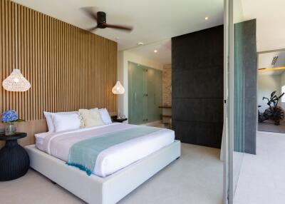 Modern bedroom with large bed, decorative elements, and access to balcony