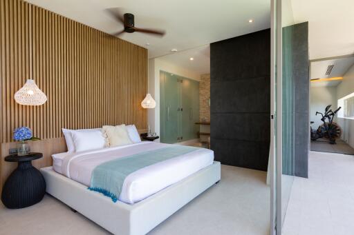 Modern bedroom with large bed, decorative elements, and access to balcony