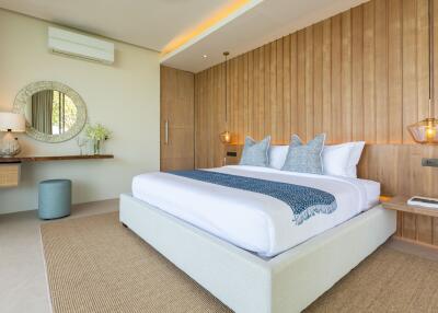 Modern well-lit bedroom with a large bed and decorative wooden wall