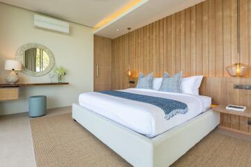 Modern well-lit bedroom with a large bed and decorative wooden wall