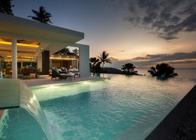 Luxurious outdoor space with infinity pool and ocean view at sunset