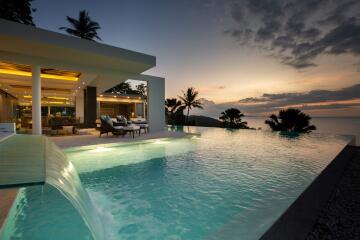 Luxurious outdoor space with infinity pool and ocean view at sunset