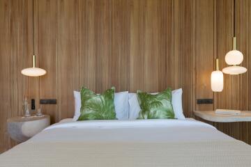 Modern bedroom with wooden accent wall and green pillows