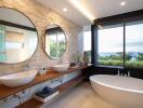 Modern bathroom with dual sinks, large mirrors, and a view