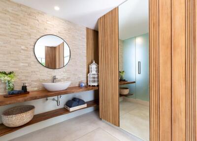 Modern bathroom with large mirror and wooden accents