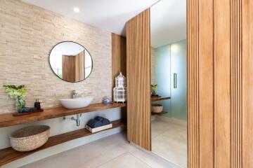 Modern bathroom with large mirror and wooden accents