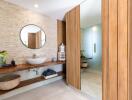 Modern bathroom with large mirror and wooden accents