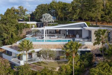 Modern luxury villa surrounded by greenery with an infinity pool